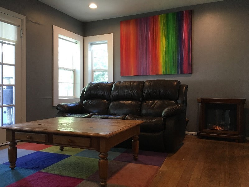 Living room with leather couch. The outer chairs recline on the couch. 