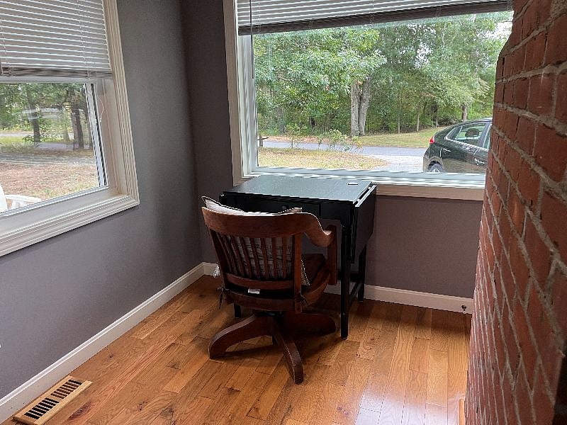 Home office with picture window view of Swan Pond River Conservation Area and becomes a good water view when the foliage thins out in the cooler months.