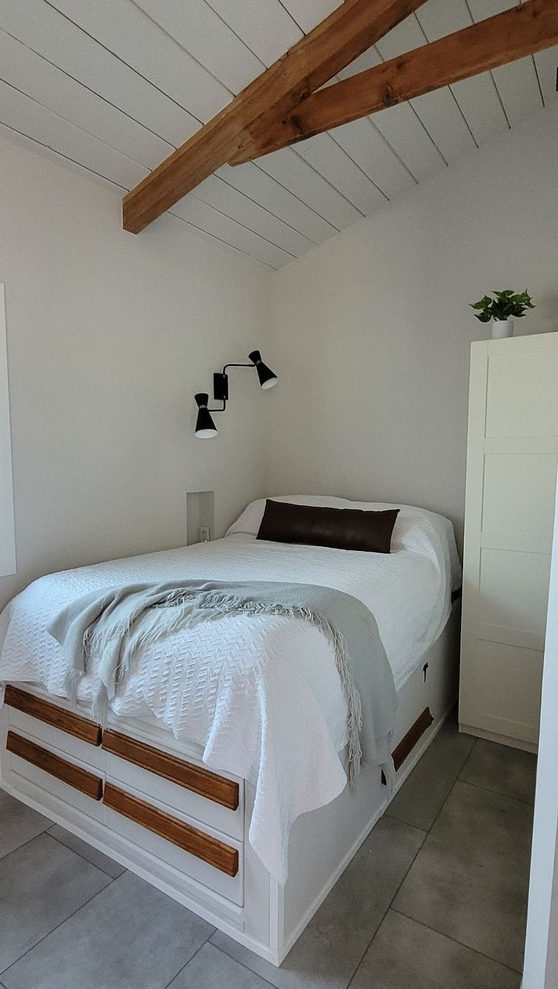 built-in standard sized bed with outlet in cubby