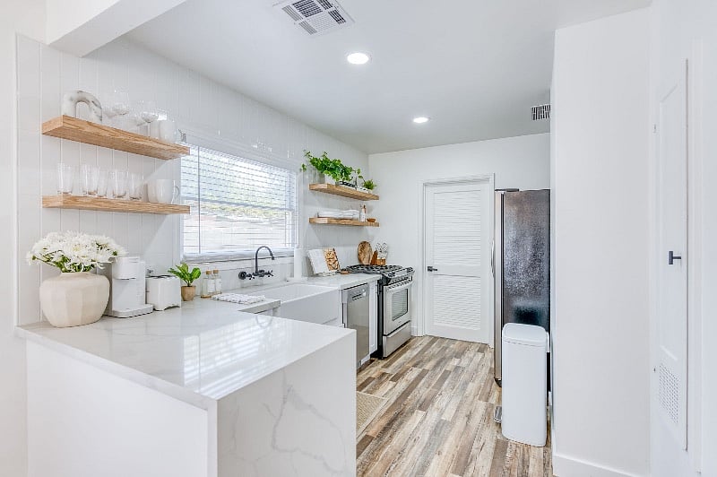 Brand new, completely renovated kitchen is open and airy with FULL SIZED FRIDGE