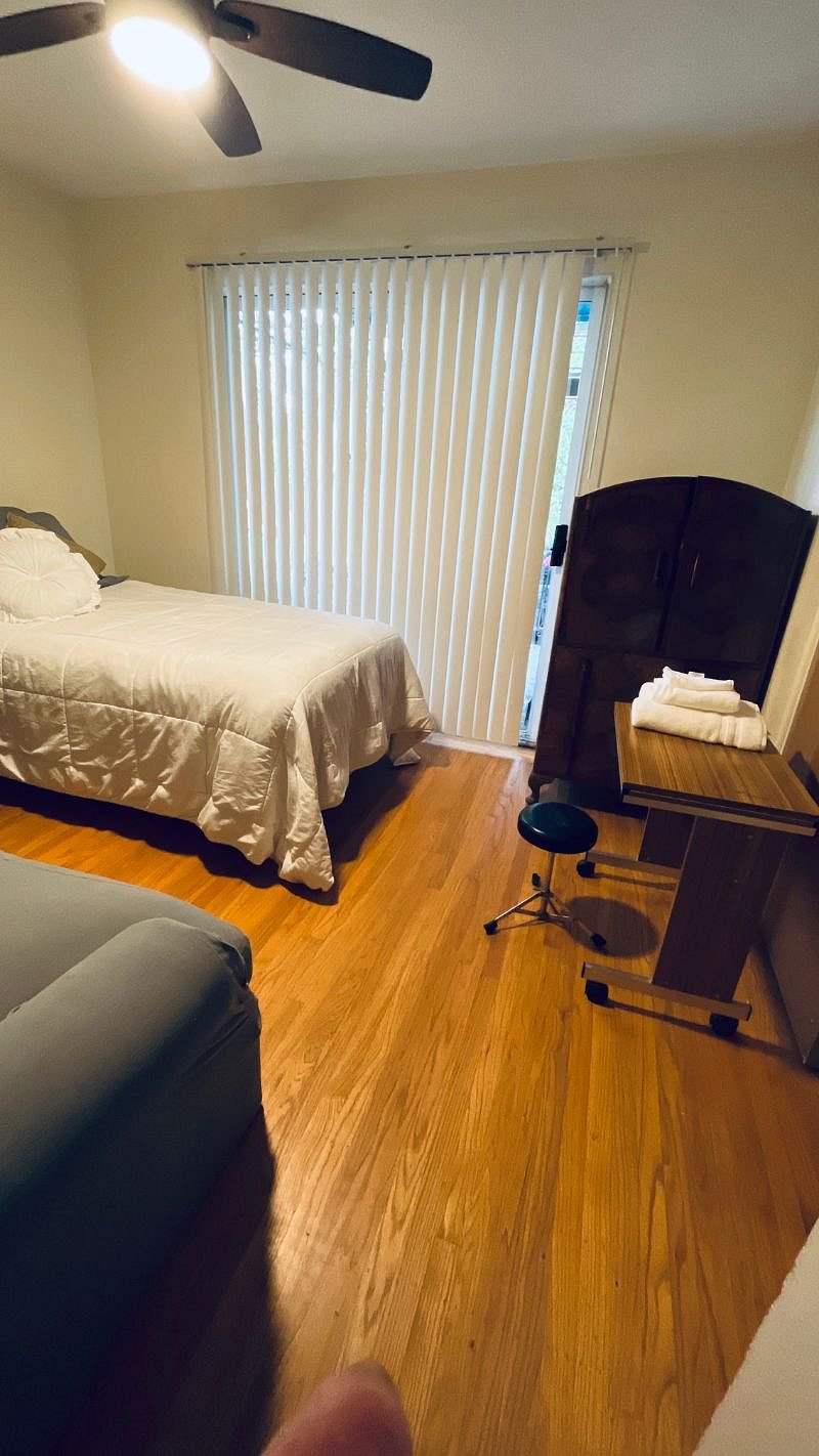 2nd bedroom with single bed view of vertical blinds closed.