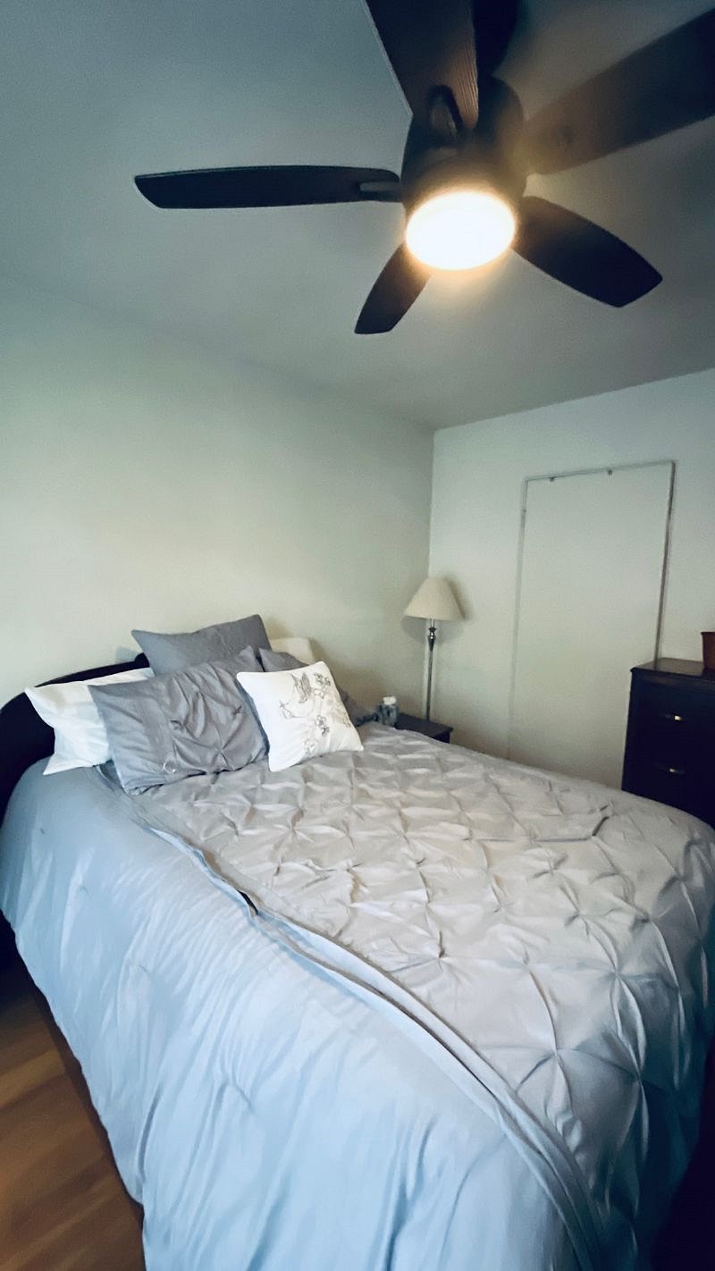 Bedroom has a queen bed, 3 way mirror vanity, dressers, round table with seating, sliding door to deck.