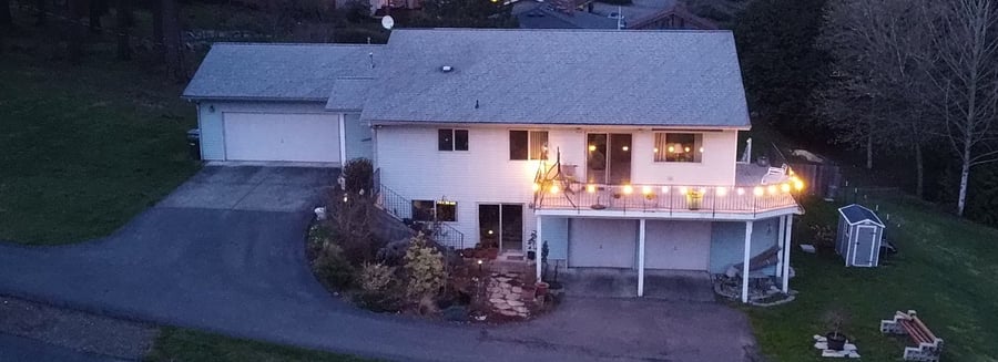 Twilight aerial of house. Note, the landscaping has filled in since this was taken.