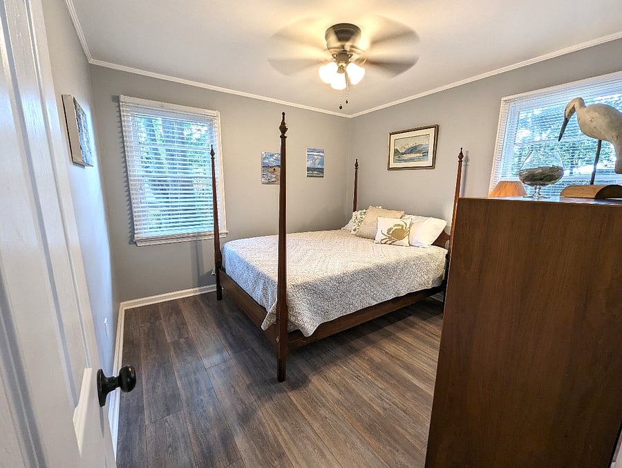 Bedroom 1 is bright and inviting. Queen bed, original art and a closet.