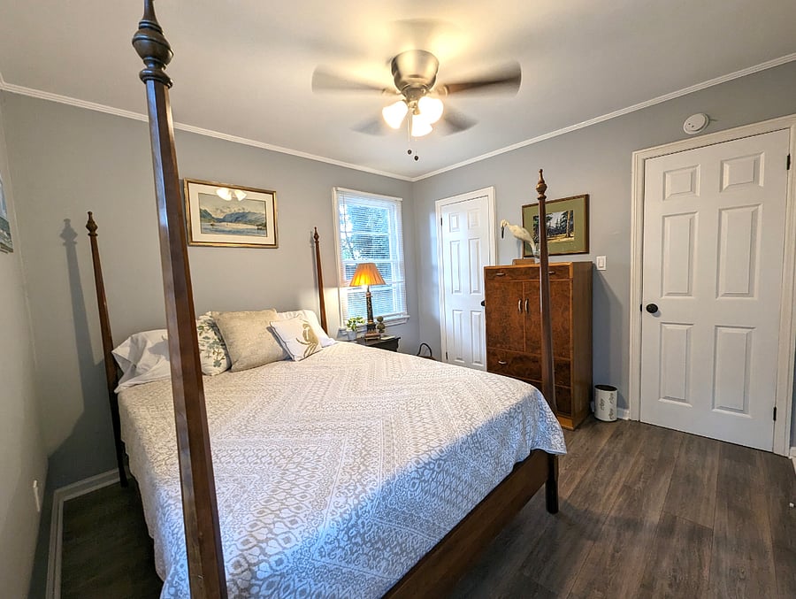 Bedroom 1 is bright and inviting. Queen bed, original art and a closet.