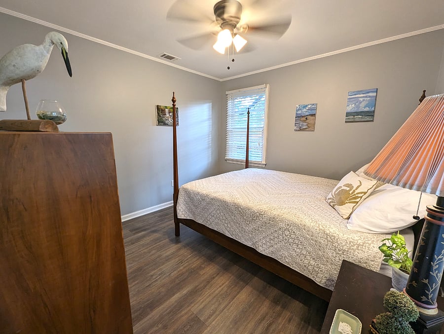 Bedroom 1 is bright and inviting. Queen bed, original art and a closet.