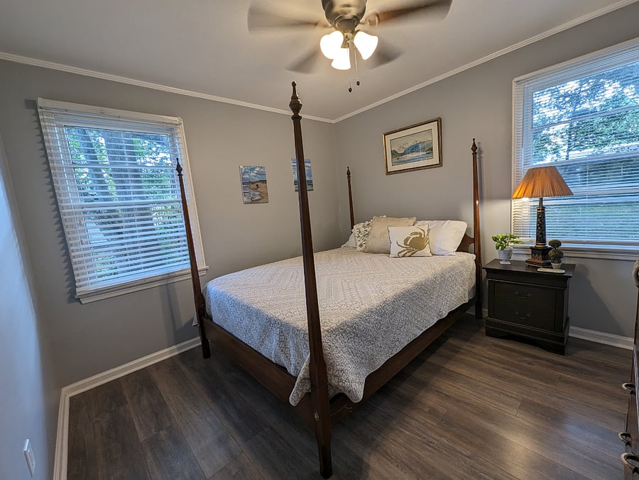 Bedroom 1 is bright and inviting. Queen bed, original art and a closet.