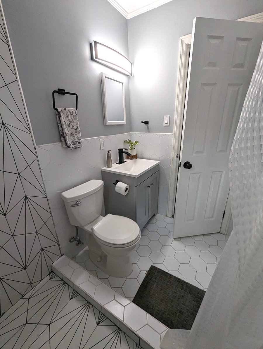Newly renovated bath with custom tile and rainfall shower.