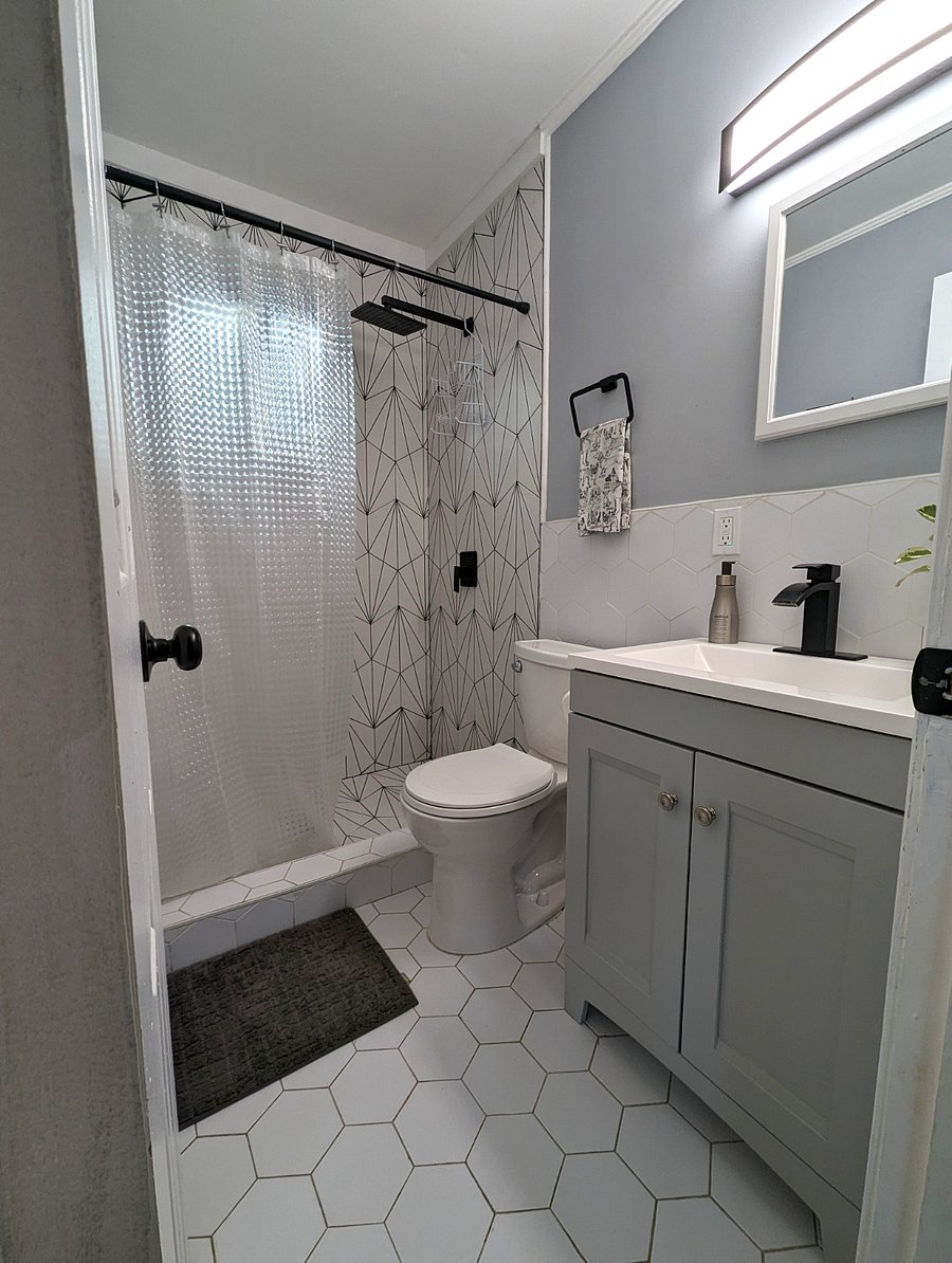 Newly renovated bath with custom tile and rainfall shower.