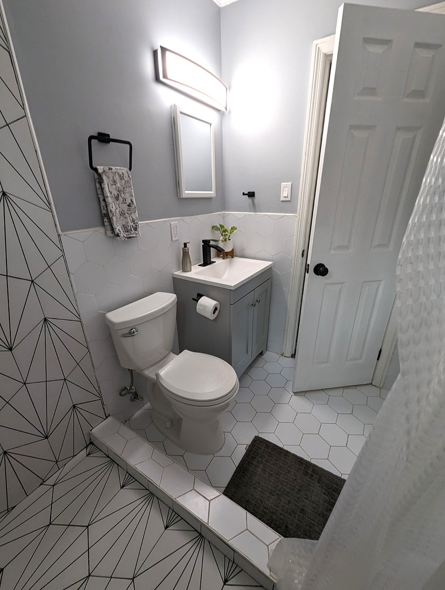 Newly renovated bath with custom tile and rainfall shower.