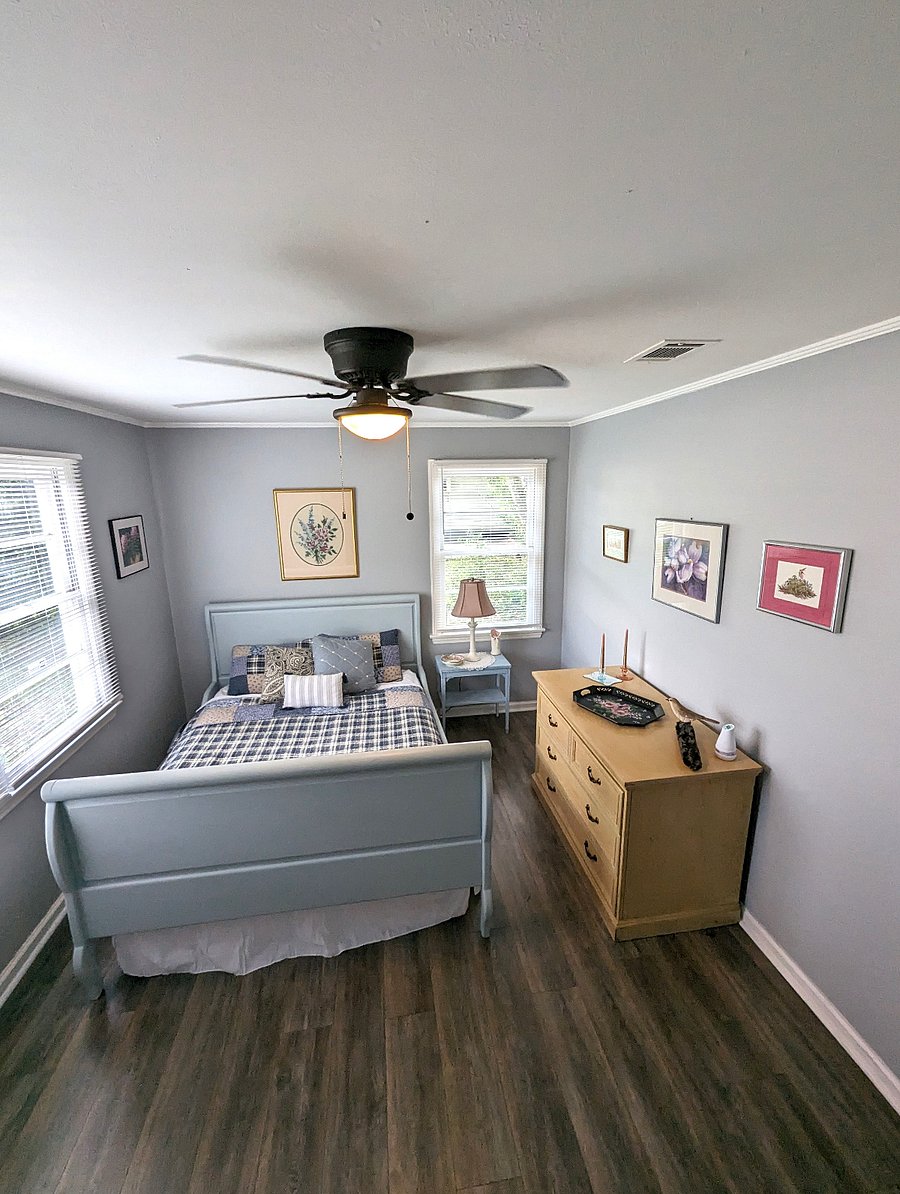 Bedroom 2 is warm and cozy. Queen bed, original art and a closet.