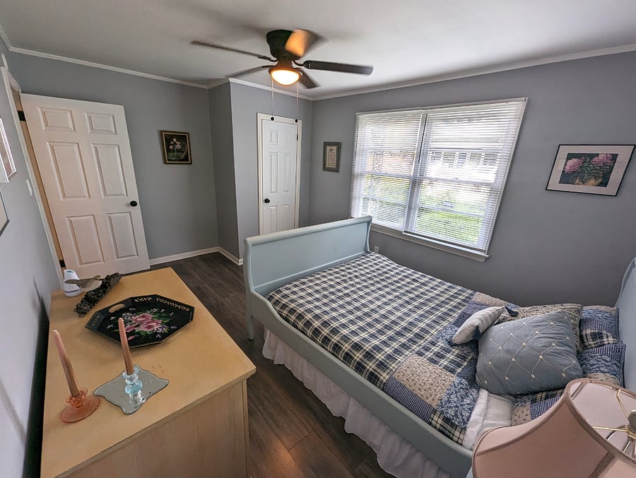Bedroom 2 is warm and cozy. Queen bed, original art and a closet.