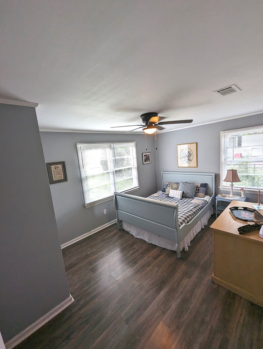 Bedroom 2 is warm and cozy. Queen bed, original art and a closet.