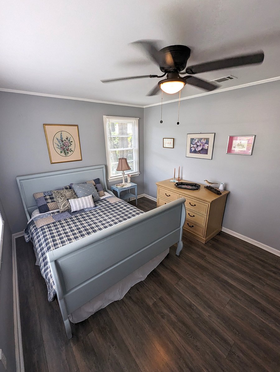 Bedroom 2 is warm and cozy. Queen bed, original art and a closet.
