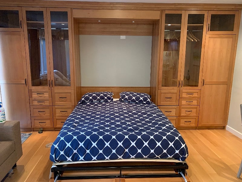 Murphy Bed folded down with high quality mattress and bedding.