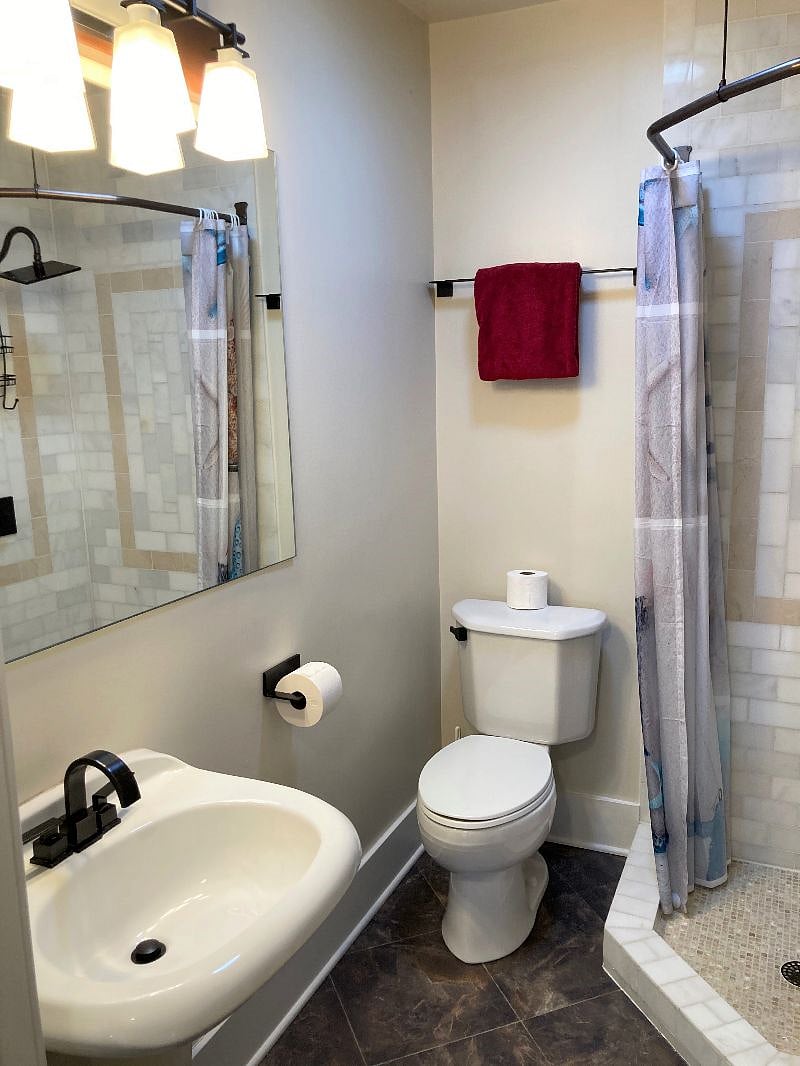 3 piece bathroom with sink, toilet and shower. 