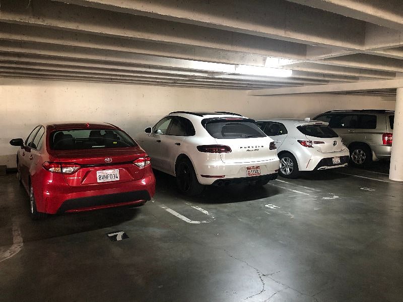 Dedicated private garage parking.  White car in middle.