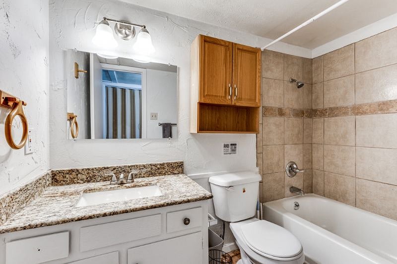 The sparkling bathroom with a relaxing bath and overhead shower.