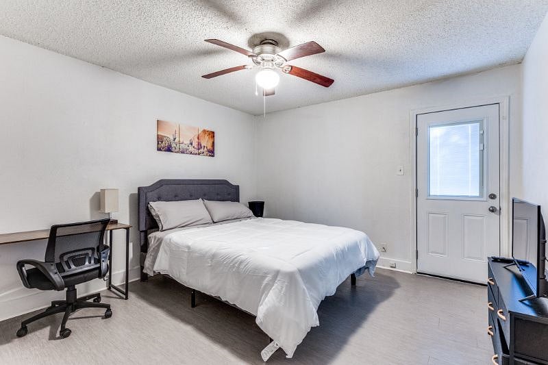 The stylish bedroom offers a comfortable queen bed, a Smart TV and a workspace.