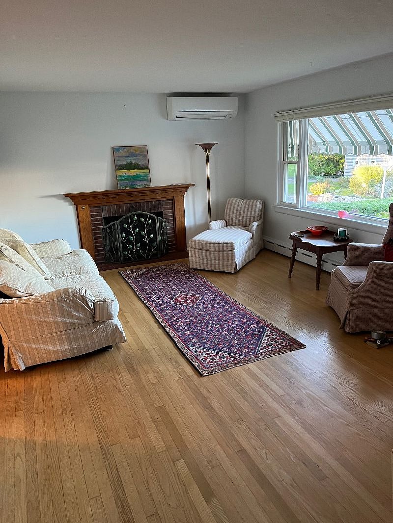 Spacious and sunny large living room, with peek-a-boo water views of the LI Sound