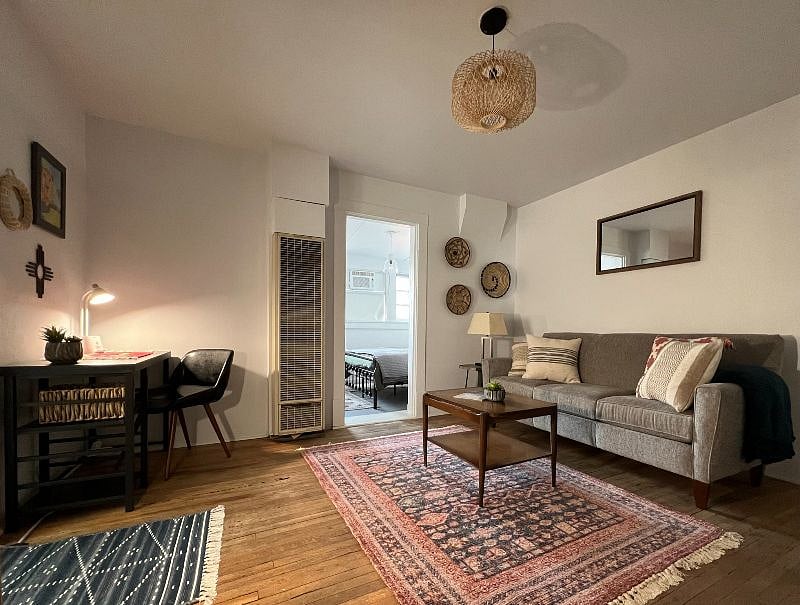 LIVING ROOM with cozy couch, pillow, throw blanket, side table with lamp