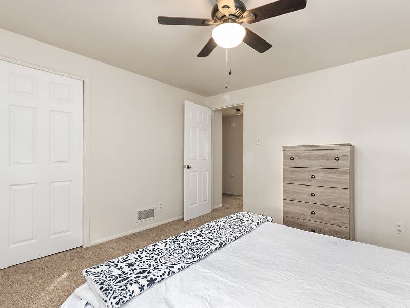 Bedroom 1. Queen bed with New bedding, new carpet, fresh paint and new ceiling fan