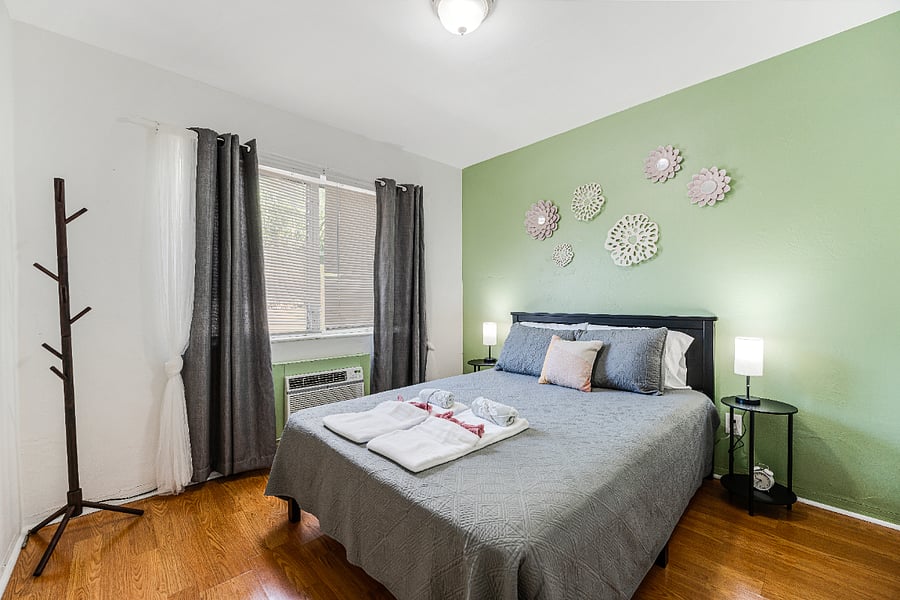 Spacious bedroom featuring a cozy queen-size bed, designed for a restful night's sleep.