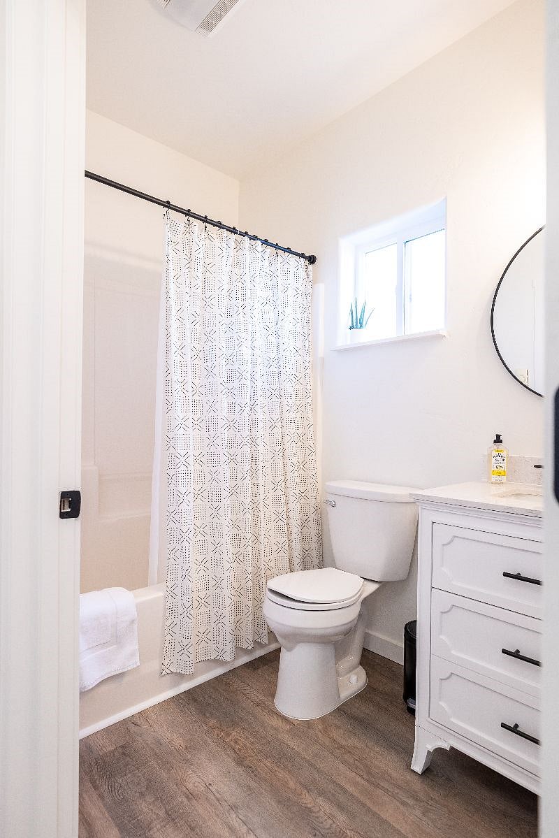 One of the bathrooms includes a shower with a tub