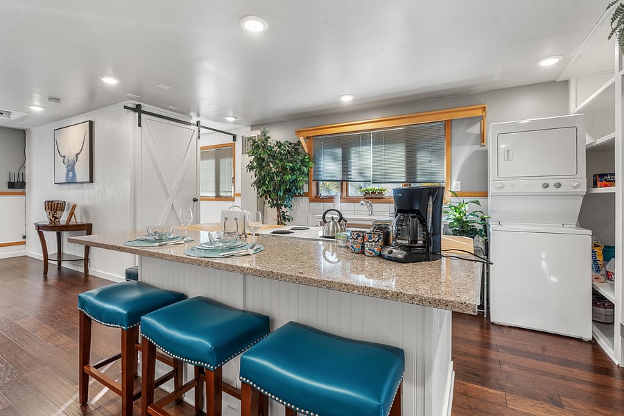 Bar area and stacked washer/dryer.