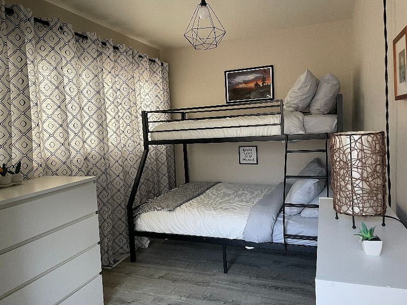 Second bedroom with twin over full bunk bed and dresser