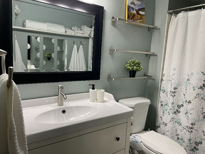 Master bathroom with tub and storage