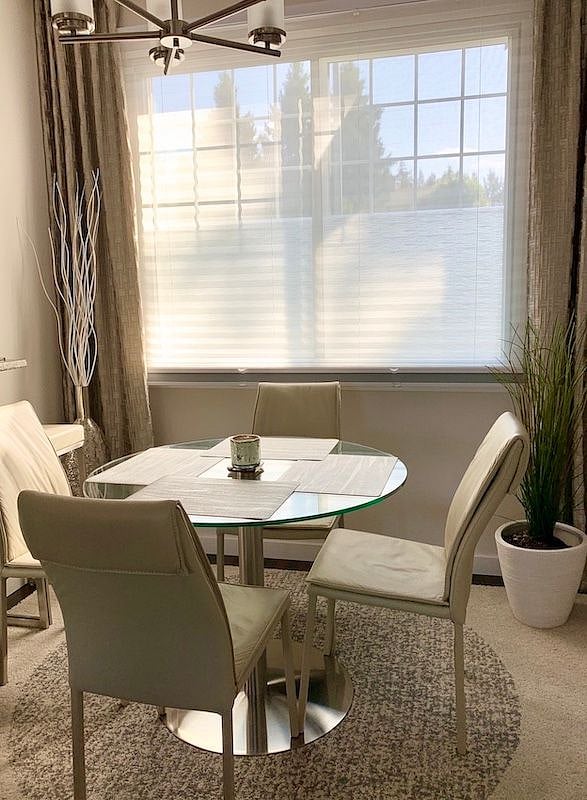 High-end leather dining chairs paired with a modern glass table