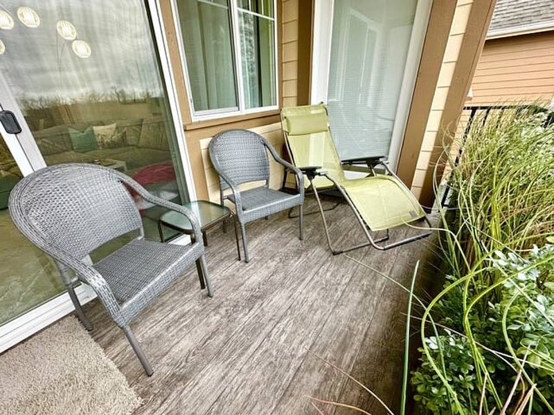 Covered balcony seating area (living room + primary suite access)