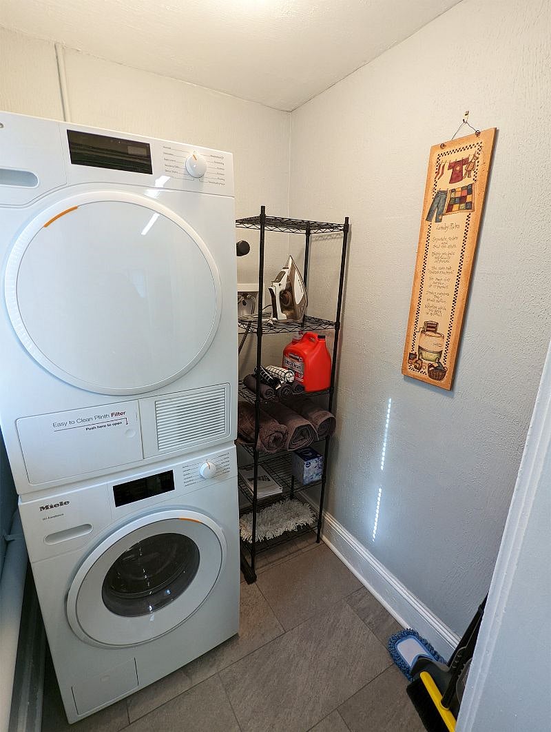 Top-of-the-line Miele washer and dryer, iron & board, shelving for supplies, extra linens and more