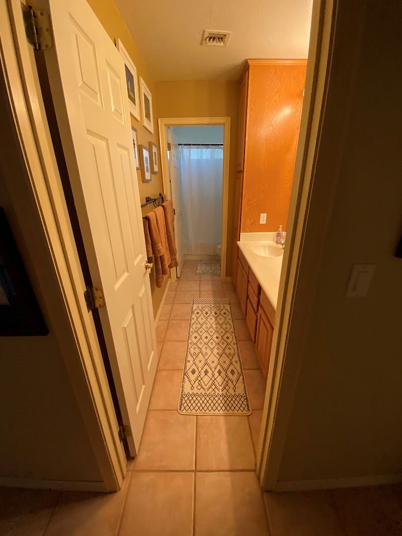 View looking in the semi-private bathroom. Shower is only shared if one of kids comes home for a visit. Bathroom is equipped with double sinks.