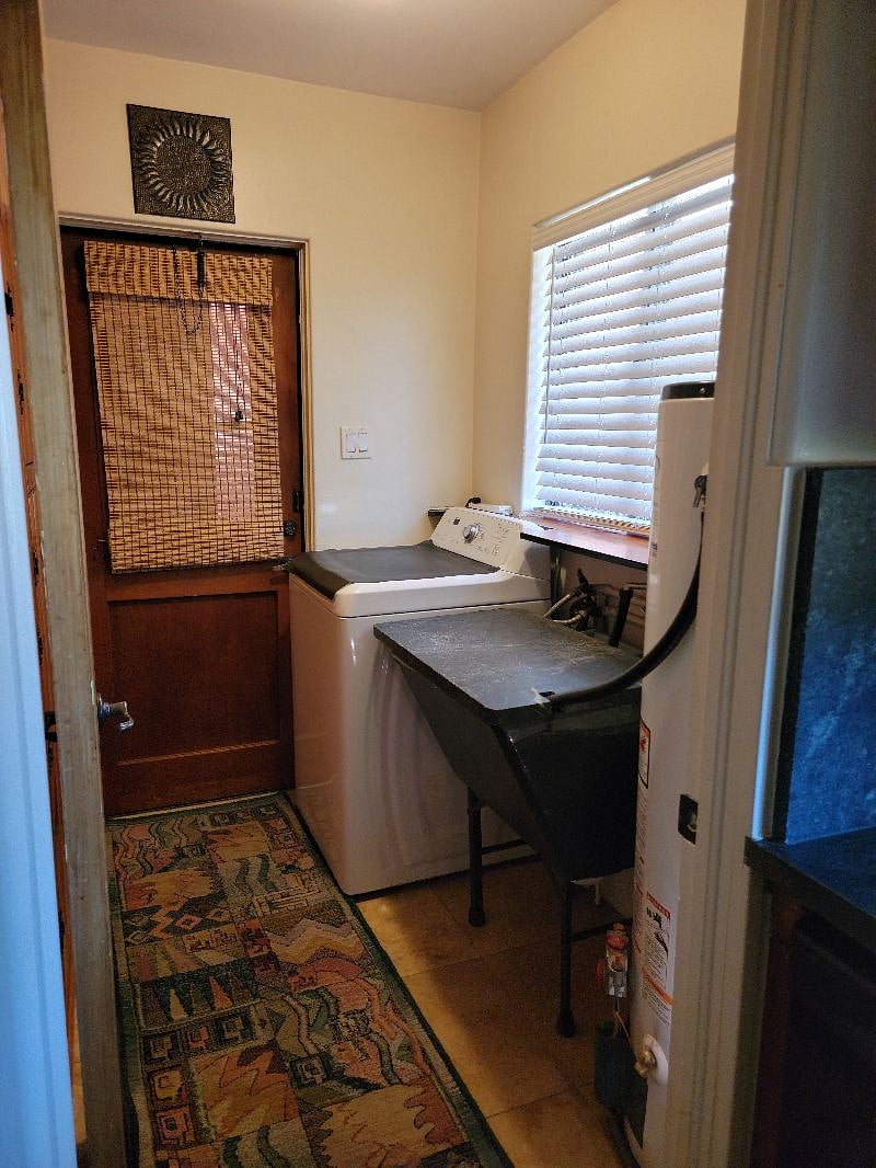 Laundry room/pantry with utility sink. Convenient back door access to carport and storage shed.