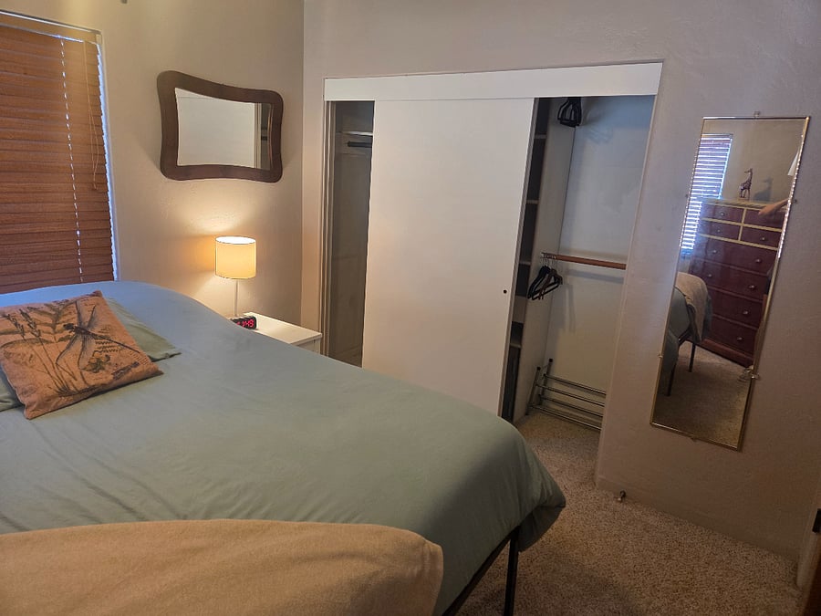Double closet with middle shelf and floor safe.