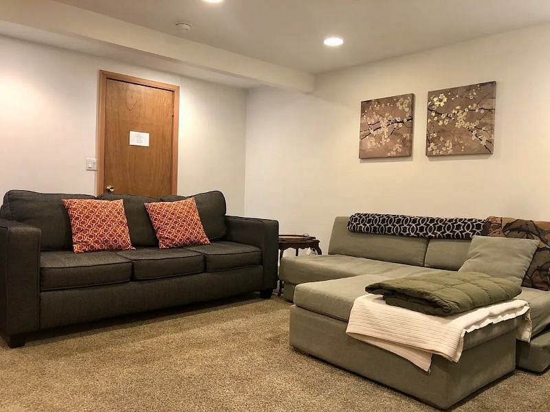 Lowel level family room with tv and relaxing sofas.
