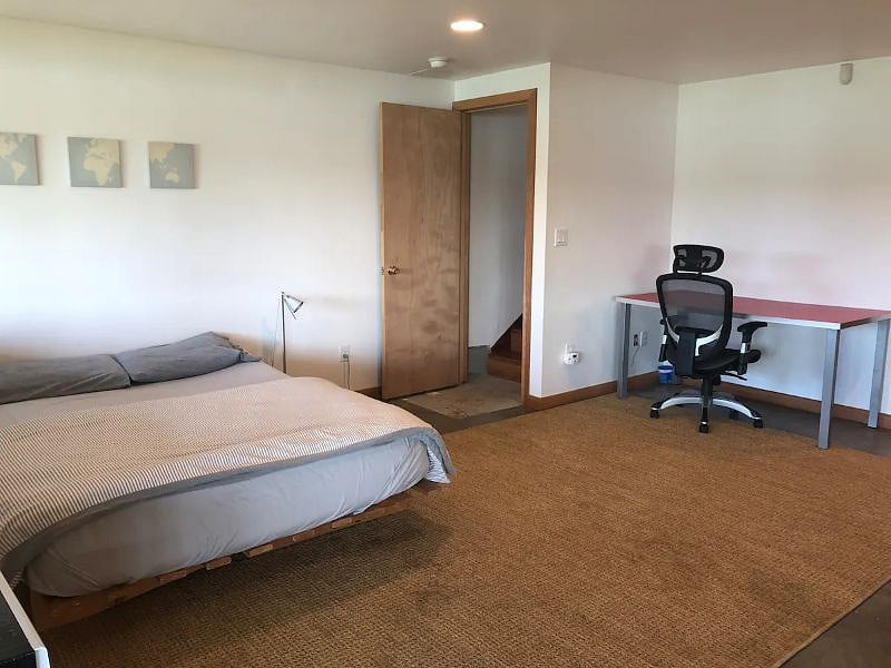 The lower is open concept with queen size futon and desk to work at.