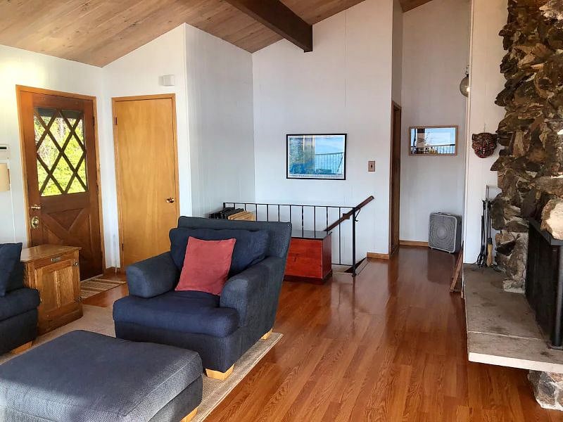 Mid century modern layout with white oak ceilings and walls of windows.