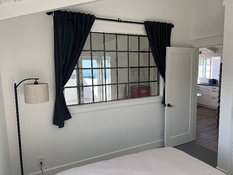 Interior window with ocean views from bedroom