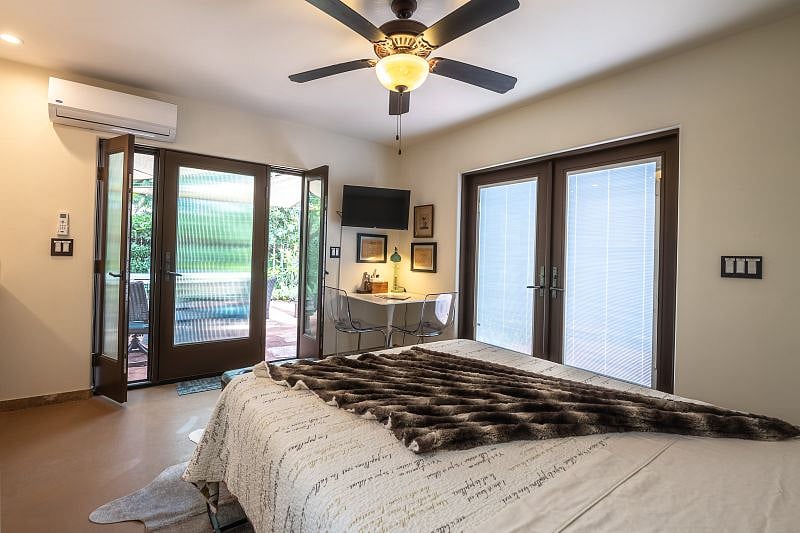 Built in privacy blinds in French doors to the right and privacy glass door with two privacy side lights that open to the left. Ceiling fan and mini split system cool and heat the unit.