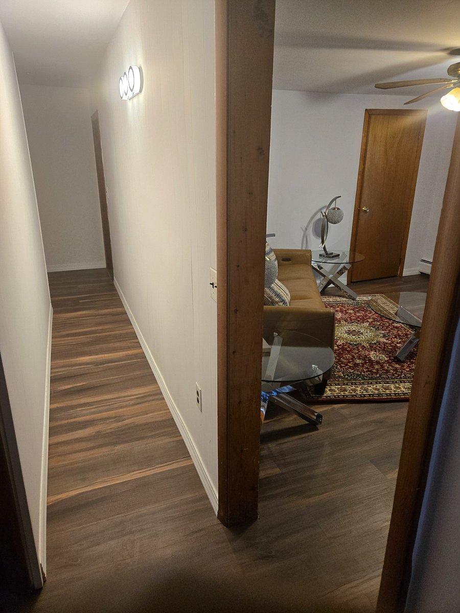 Step into a warm, simple and modern Living room ( with deep Leather Cushioning Mullican Zero Gravity Power Sofa with Power Headrest with soft light on either sides for reading or socializing )/ Bedroom Hall