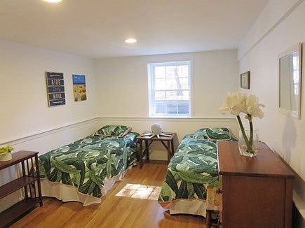 Lower level bedroom with two twin beds and play area. We sometimes use this area as our second working space when working from home.