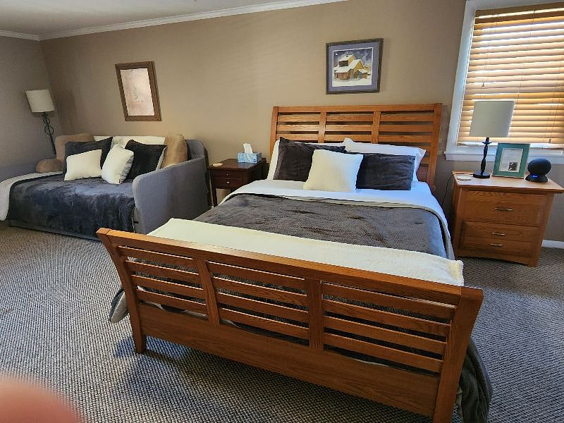Guest room complete with Queen size bed as well as Day Bed with Trundle. In addition to potential additional sleeping surfaces, this keeps the space more open while providing nice seating for watching the guest room TV.