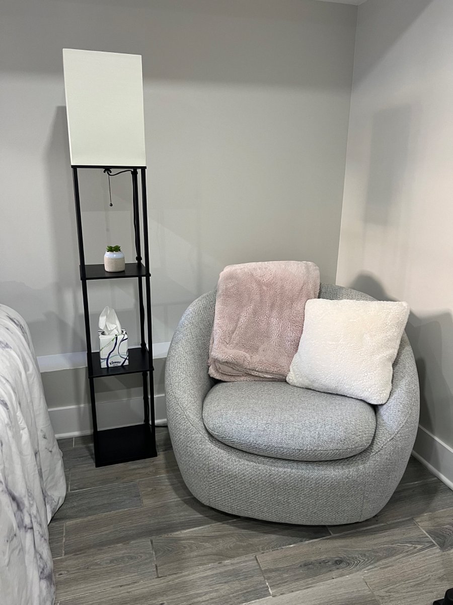 Cozy reading nook in bedroom w/ West Elm rotating chair.