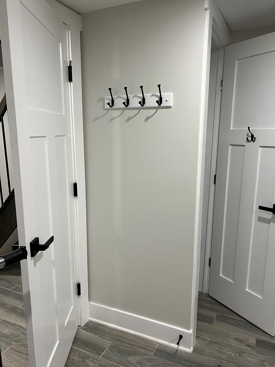 Purse hook on wall in bedroom
