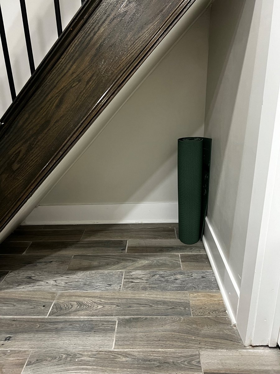 Storage under staircase for suitcases, bags, etc. Yoga/work out mat.