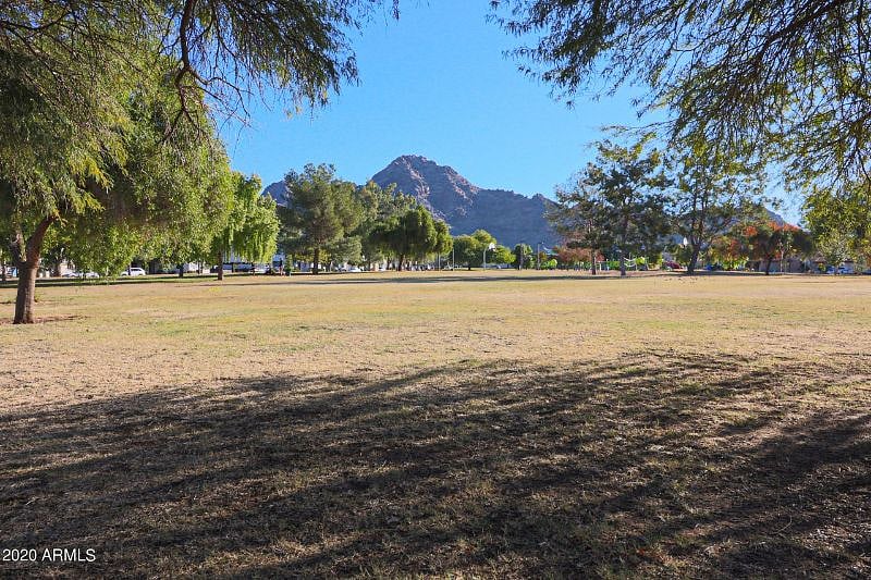 park across the street with basketball hoops, volleyball, a playground, ample space to walk and views of the mountains