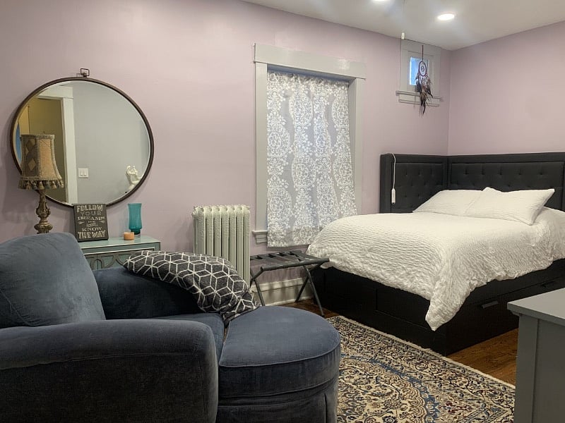 second bedroom with full bed and wall mounted tv